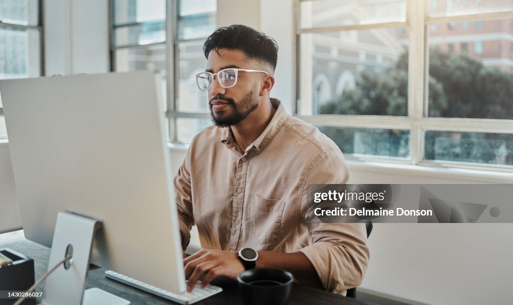 Information technology businessman working on computer in office for digital app, software development or website ux ui design. Young graphic designer with coding project or online company management