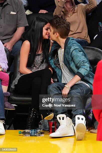 Selena Gomez and Justin Bieber kiss at a basketball game between the San Antonio Spurs and the Los Angeles Lakers at Staples Center on April 17, 2012...