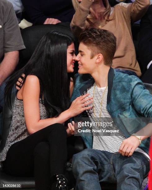 Selena Gomez and Justin Bieber kiss at a basketball game between the San Antonio Spurs and the Los Angeles Lakers at Staples Center on April 17, 2012...