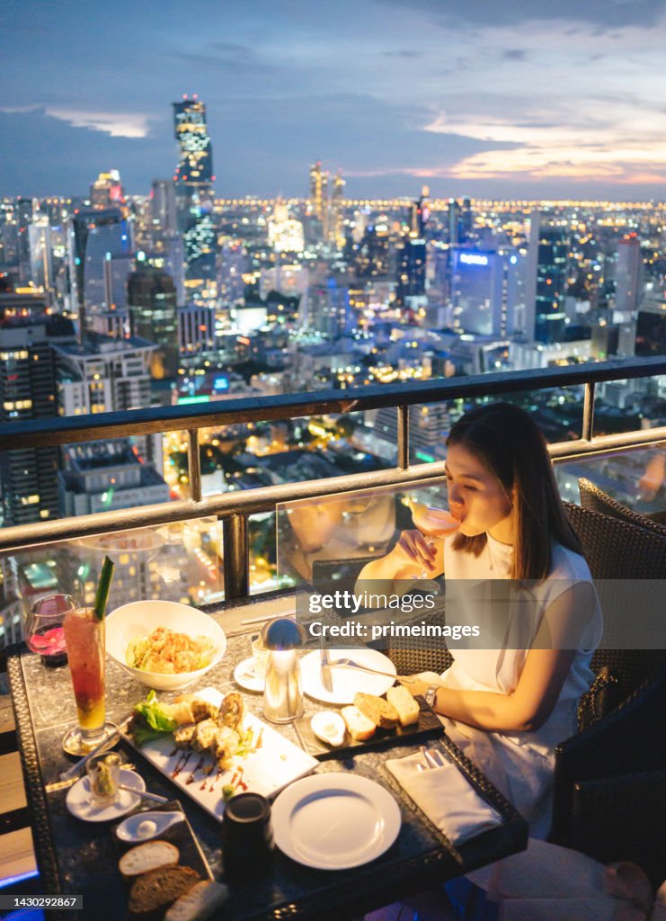 Asian beautiful adult using mobile smartphone capturing Luxury dinner celebration