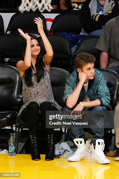 Selena Gomez and Justin Bieber attend a basketball game between the San Antonio Spurs and the Los Angeles Lakers at Staples Center on April 17, 2012...