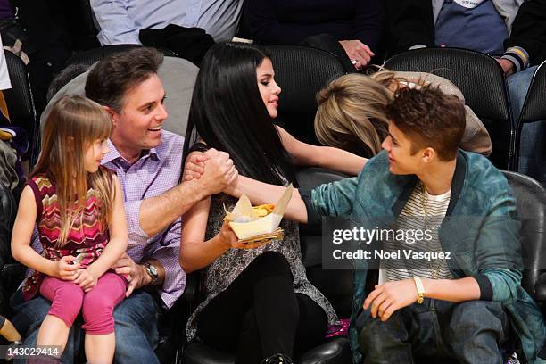 Selena Gomez and Justin Bieber attend a basketball game between the San Antonio Spurs and the Los Angeles Lakers at Staples Center on April 17, 2012...