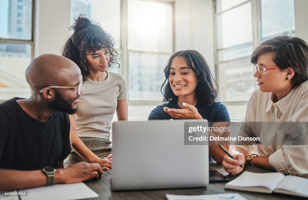 Laptop, digital marketing and team in a meeting planning seo, advertising and innovation strategy as a group. Creative, diversity and young people working on branding ideas for a startup project