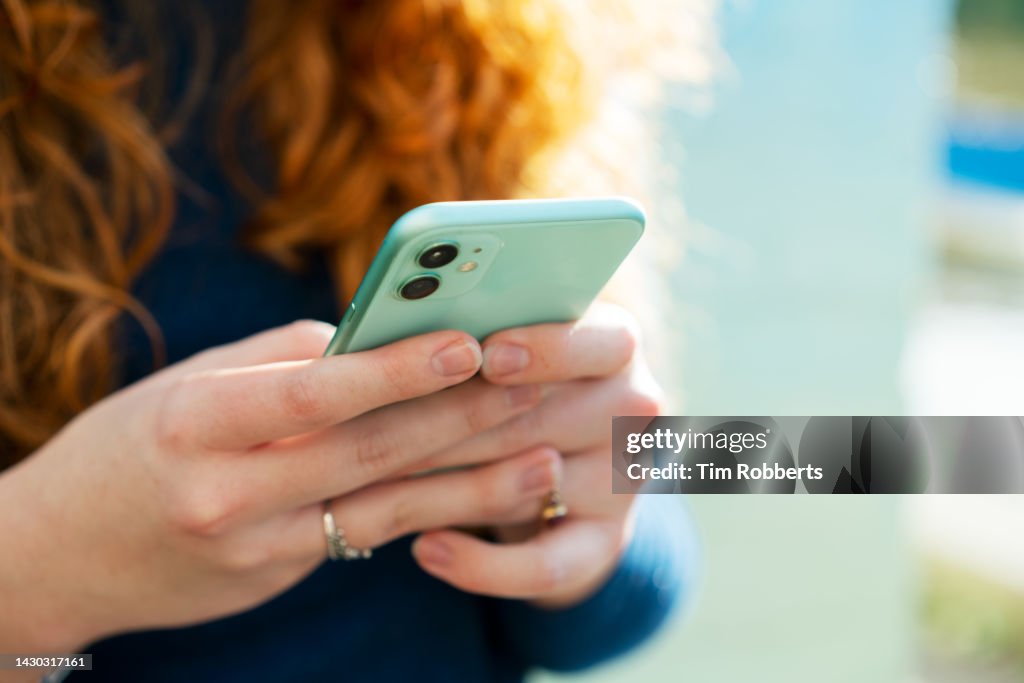 Close up or woman using smart phone