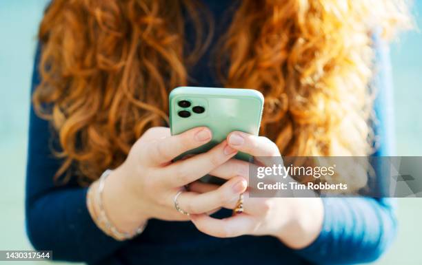 close up or woman using smart phone - text message stockfoto's en -beelden