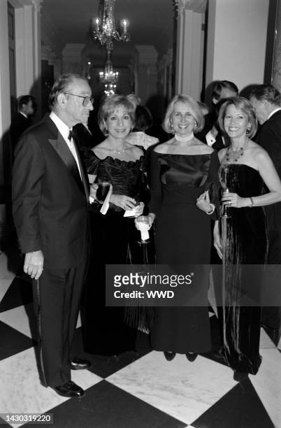 Alan Greenspan, Andrea Mitchell, Sally Quinn, and Catherine Meyer attend a party at the British embassy in Washington, D.C., on November 5, 1998.