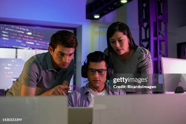 programming engineers are developing codes on their computers - game three stockfoto's en -beelden