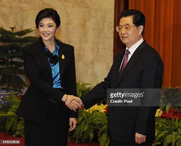 Thailand's Prime Minister Yingluck Shinawatra shakes hands with Chinese President Hu Jintao as they meet to hold talks at the Great Hall of the...