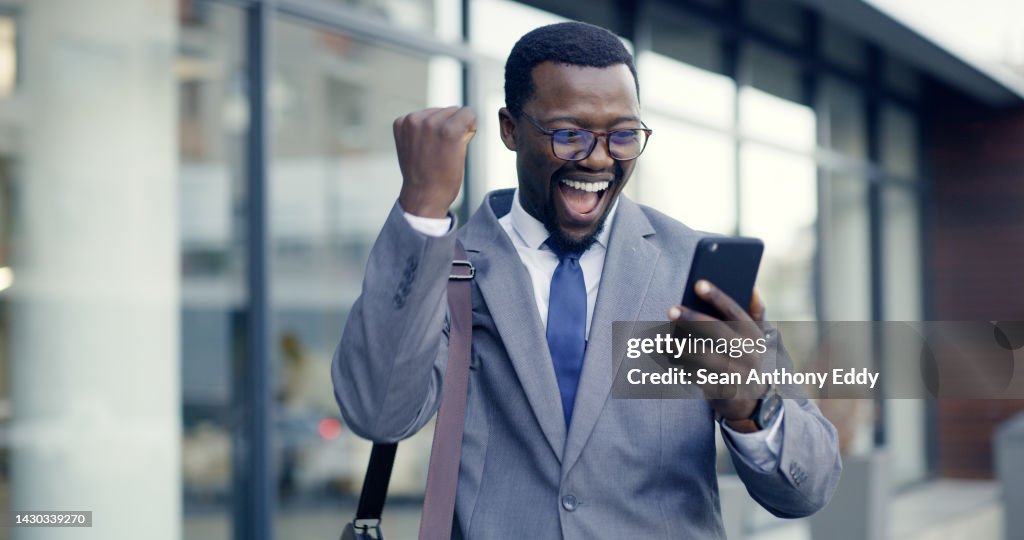 City businessman, celebration and phone success for surprise winner news, trading sales and happy fist announcement. Excited executive reading mobile notification, bonus deal and winning stock profit