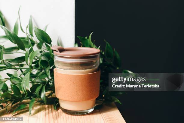 reusable ecological beverage cup in a modern composition. zero waste lifestyle. eco-friendly product. - imitation stock photos et images de collection