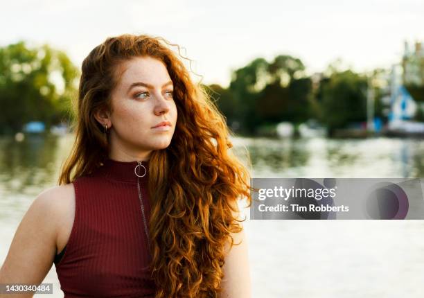 woman looking away next to water - lake auburn stock pictures, royalty-free photos & images