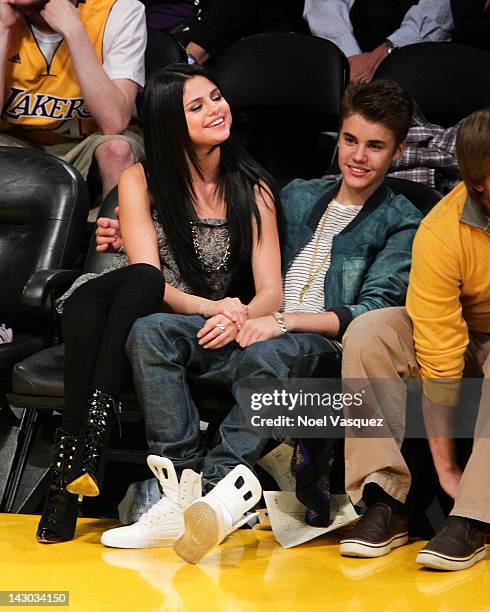 Selena Gomez and Justin Bieber attend a basketball game between the San Antonio Spurs and the Los Angeles Lakers at Staples Center on April 17, 2012...