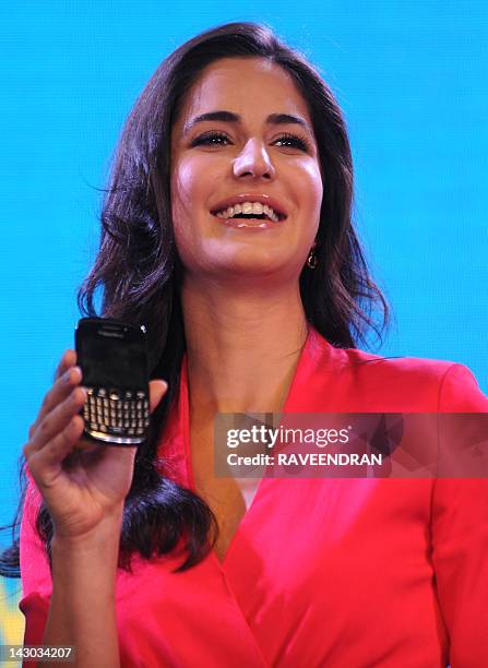 Bollywood film actress Katrina Kaif displays a BlackBerry Curve 9220 during the product launch in New Delhi on April 18, 2012. The new BlackBerry...