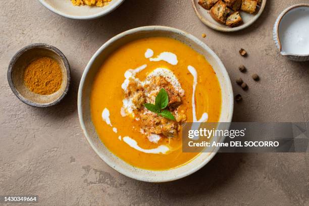 homemade carrot lentil pumpkin and cream soup with basil - winter squash stock pictures, royalty-free photos & images