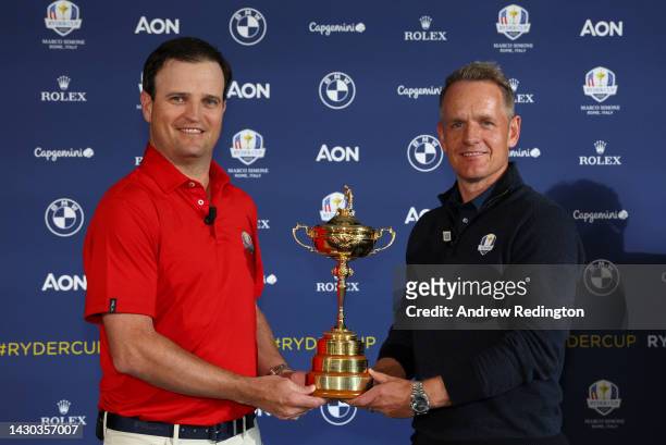 Team Captains Zach Johnson of The United States and Luke Donald of England pose with the Ryder Cup trophy following a press conference during the...
