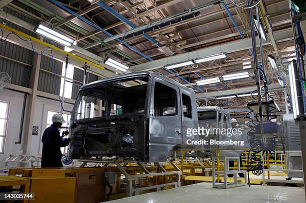 Employees work on the assembly of BharatBenz trucks on the production line at the new Daimler AG truck factory in Kancheepuram, India, on Wednesday,...