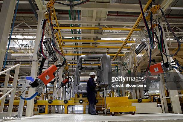 An employee works on the assembly of BharatBenz trucks on the production line at the new Daimler AG truck factory in Kancheepuram, India, on...