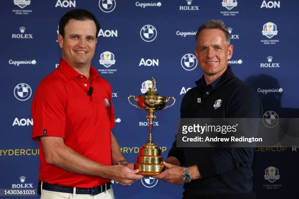 Team Captains Zach Johnson of The United States and Luke Donald of England pose with the Ryder Cup trophy following a press conference during the...