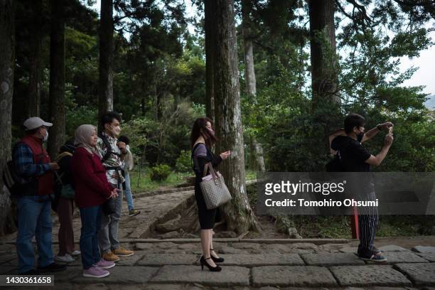 Tourists wait in line to photograph the Torii of Peace at Hakone Shrine on October 04, 2022 in Hakone, Japan. Japan's Prime Minister Fumio Kishida...