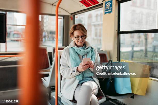 ältere frau im bus - telefonkarte stock-fotos und bilder
