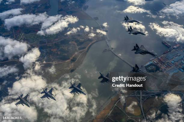 In this handout image released by the South Korean Defense Ministry, South Korean Air Force F-15Ks and U.S. Air Force F-16 fighter jets fly over the...