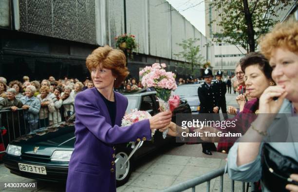 Lady Sarah Mccorquodale takes a bouquet of flowers from a woman in the crowd during a walkabout in Nottingham. Lady Sarah took on the role of...