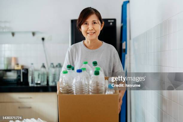 asian woman recycling plastic bottles - bottle bank stock pictures, royalty-free photos & images