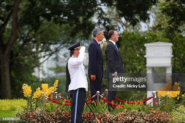 New Zealand Prime Minister John Key stands with Singapore Prime Minister Lee Hsien Loong during a honour guard welcome ceremony at the Istana on...