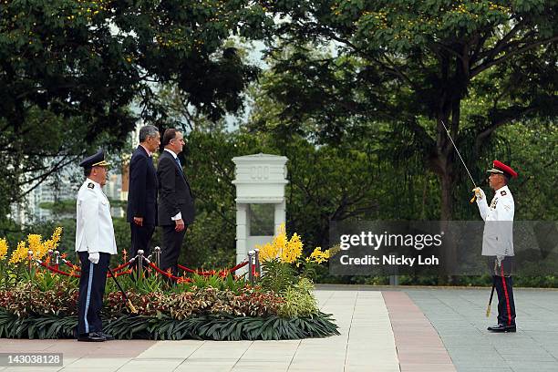 New Zealand Prime Minister John Key stands with Singapore Prime Minister Lee Hsien Loong during a honour guard welcome ceremony at the Istana on...