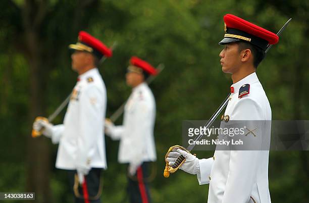Honour guards stand in line as they await New Zealand Prime Minister John Key to inspect them at the Istana on April 18, 2012 in Singapore. New...