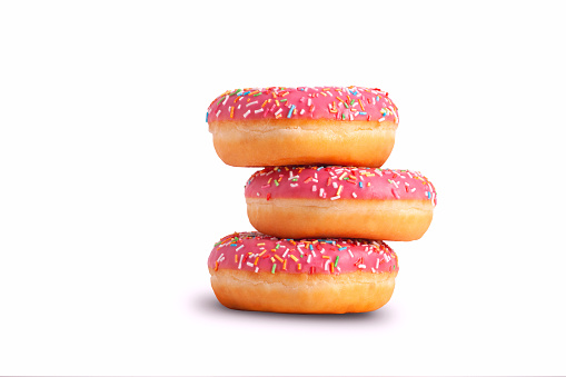 Stack of glazed donuts with pink icing. Isolated on white background.