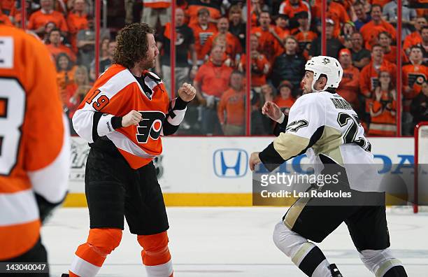 Scott Hartnell of the Philadelphia Flyers fights against Craig Adams of the Pittsburgh Penguins in Game Three of the Eastern Conference Quarterfinals...