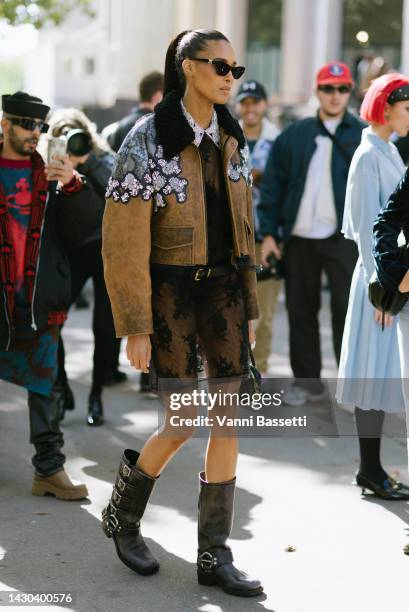 Model Cindy Bruna poses wearing a Miu Miu leather jacket, a Miu Miu dress and Miu Miu leather biker boots after the Miu Miu show at the Palais de...