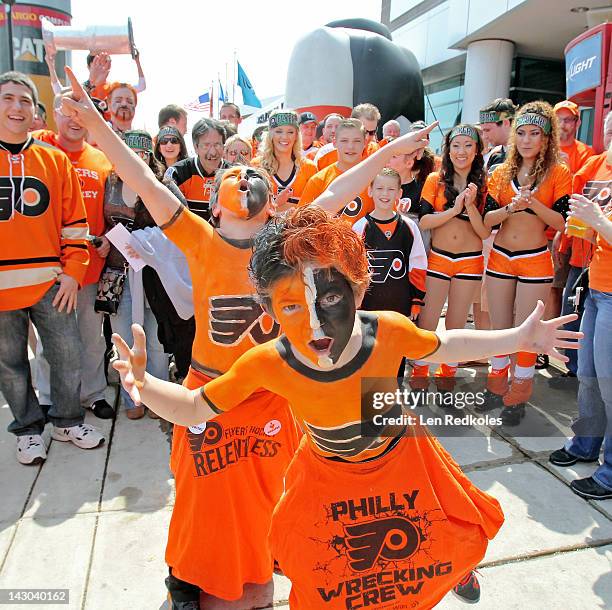 Two young fans of the Philadelphia Flyers cheer on their team prior to the start of Game Three of the Eastern Conference Quarterfinals against the...