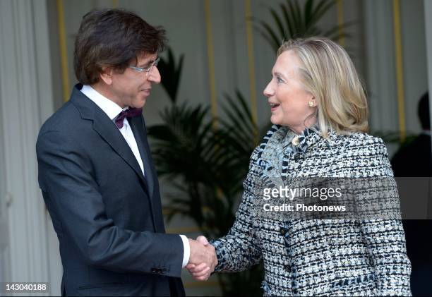 Belgian Prime Minister Elio Di Rupo shakes hands with U.S. Secretary of State Hillary Clinton at the Prime Minister's Lambermont office on April 18,...