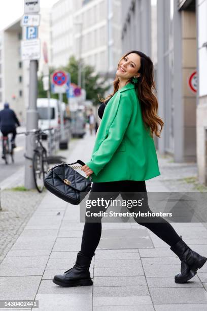 Jasmin Wagner wearing a black crop top with silver crystal fringe detail by Zara, a green blazer by na-kd, green earrings by Mango, black leggings by...