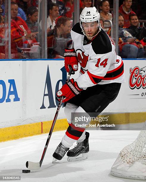 Adam Henrique of the New Jersey Devils skates with the puck behind the Florida Panthers net in Game Two of the Eastern Conference Quarterfinals...