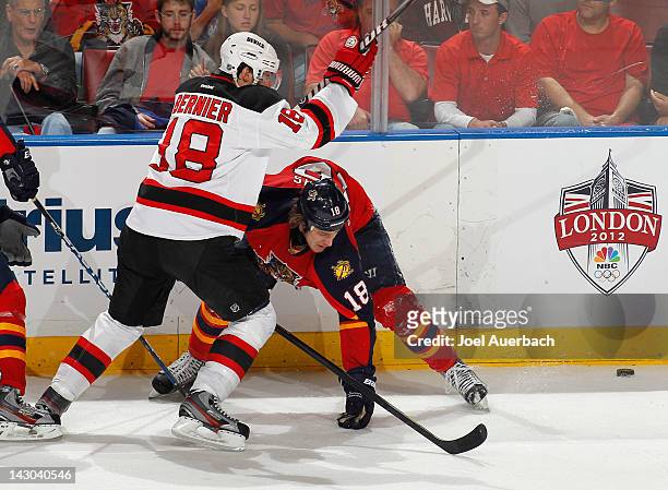 Shawn Matthias of the Florida Panthers blocks Steve Bernier of the New Jersey Devils as he skates after the loose puck in Game Two of the Eastern...
