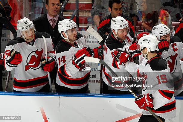 Travis Zajac of the New Jersey Devils is congratulated by teammates after scoring a goal against the Florida Panthers in Game Two of the Eastern...