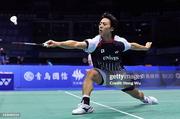 Takuma Ueda of Japan plays a shot during his match against Zhou Wenlong of China during day Two of the 2012 Badminton Asia Championships at Qingdao...