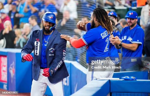 Teoscar Hernandez of the Toronto Blue Jays celebrates his home run as Vladimir Guerrero Jr. Gives him the The Blue Jacket against the Boston Red Sox...