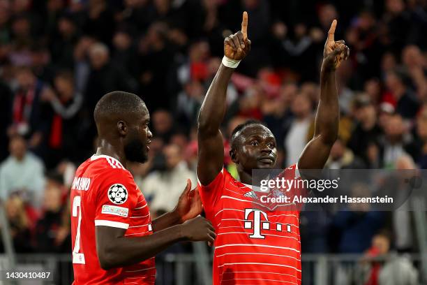 Sadio Mane celebrates with Dayot Upamecano of Bayern Munich after scoring their team's third goal during the UEFA Champions League group C match...