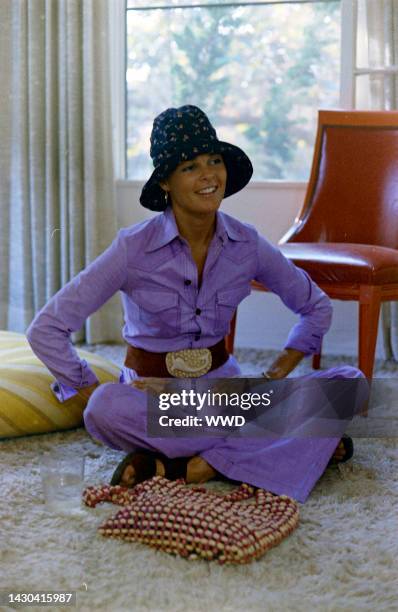 Actress Ali MacGraw sits on rug and answers questions during an interview in her friend's apartment.