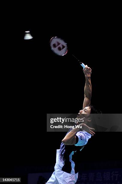 Takuma Ueda of Japan plays a shot during his match against Zhou Wenlong of China during day Two of the 2012 Badminton Asia Championships at Qingdao...