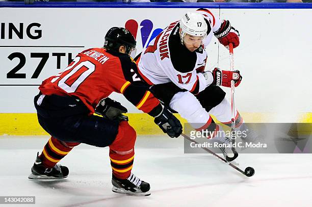 Ilya Kovalchuk of the New Jersey Devils and Sean Bergenheim of the Florida Panthers go after the puck in Game Two of the Eastern Conference...