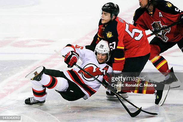 Patrik Elias of the New Jersey Devils tangles with Marcel Goc of the Florida Panthers in Game Two of the Eastern Conference Quarterfinals during the...