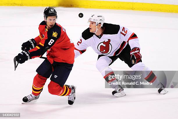 Alexei Ponikarovsky of the New Jersey Devils and Wojtek Wolski of the Florida Panthers go after the puck in Game Two of the Eastern Conference...