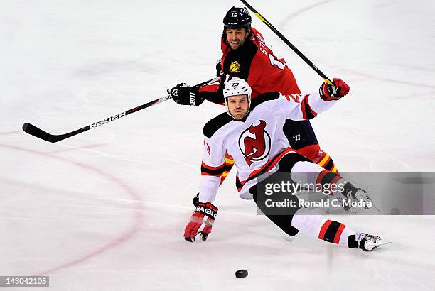 Patrik Elias of the New Jersey Devils hits the ice as Marco Sturm of the Florida Panthers chases during Game Two of the Eastern Conference...