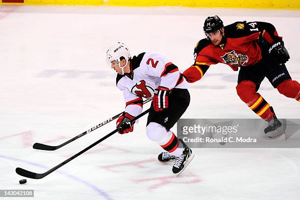 Marek Zidlicky of the New Jersey Devils skates with the puck as Tomas Fleischmann of the Florida Panthers chases during Game Two of the Eastern...