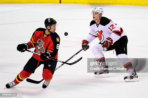 Alexei Ponikarovsky of the New Jersey Devils and Wojtek Wolski of the Florida Panthers go after the puck in Game Two of the Eastern Conference...